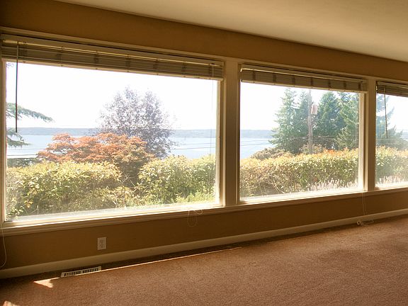 Living room windows help to take full advantage of the spectacular Puget Sound and Olympic Mt views.