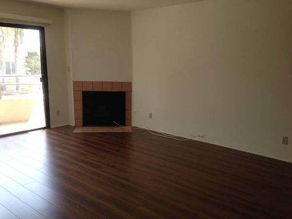Open living room with fireplace and balcony