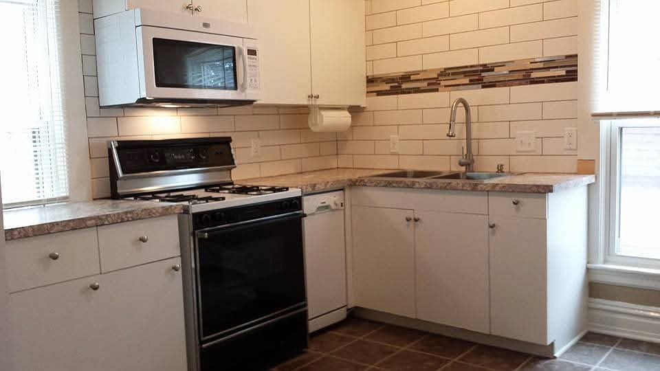 Rolling island is positioned against the wall here. The stove has been updated since these photos.