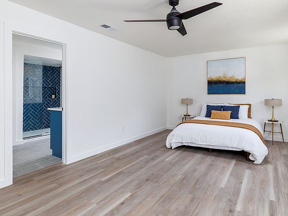 Master bedroom looking into en suite bathroom.