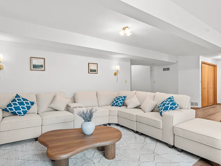 Spacious basement recreation lounge with generous seating and plenty of open space for relaxing, entertaining, or gathering with family and friends.