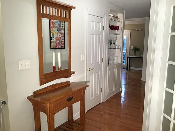 Hallway with built in cabinet, coat closet and pantry.