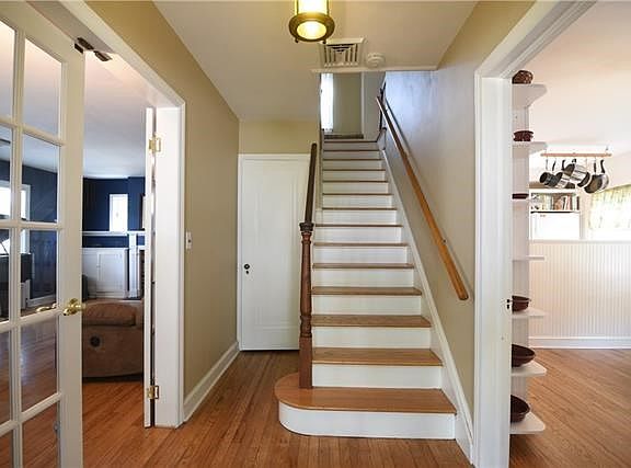 Entry Hall has large coat closet and French doors to the Living Room on the left and access to Dining Area and Kitchen on the right.