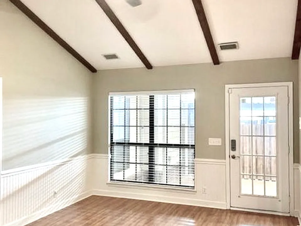 Open and Vaulted Den with Door to Patio and Two Car Covered Parking