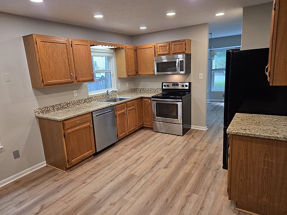 Kitchen with pantry and stainless steel/black appliances. New LED lighting.