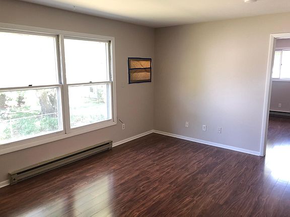 Spacious, bright living room with lovely new floors and heaps of streaming natural light!