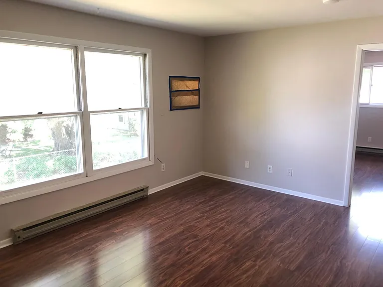 Spacious, bright living room with lovely new floors and heaps of streaming natural light!