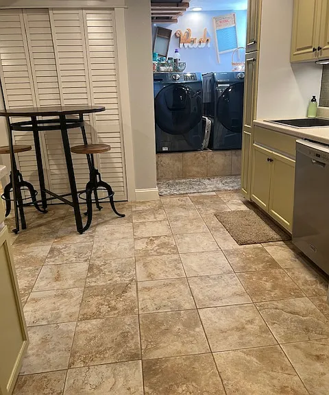 View of shared Laundry. Great Bistro table and stools for meals.