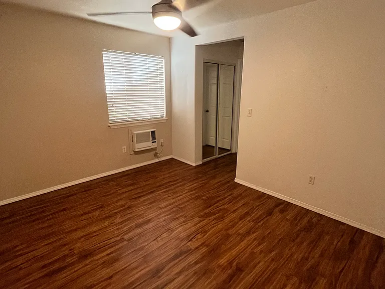 Master bedroom facing entrance to bathroom and double closet