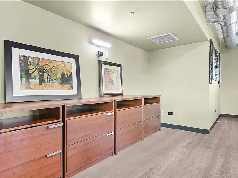 Community gathering room with games, cozy seating, and large dining table for a variety of engageing events.