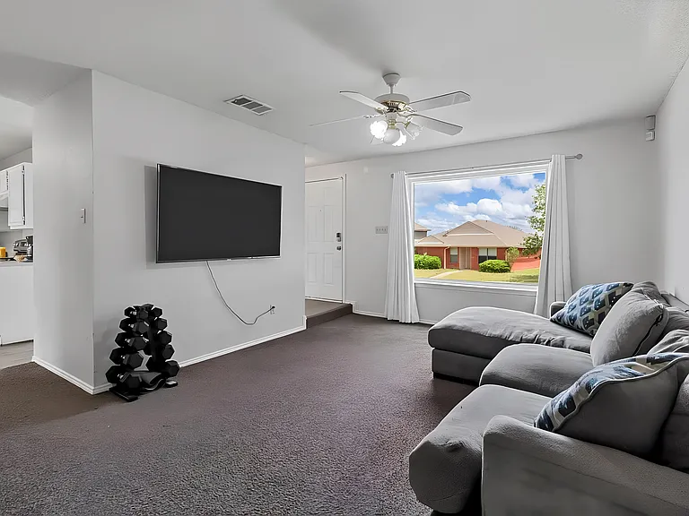 Lounging Space with view of kitchen and front entrance