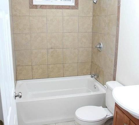 Bath with ceramic floor and tub surround
