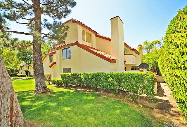View of the side of the condo from the shaded green space