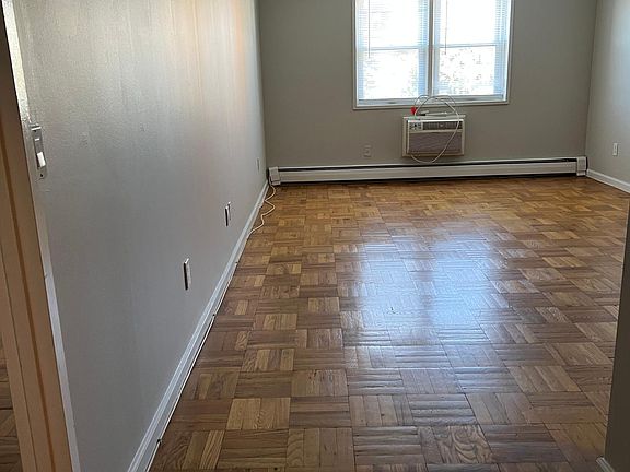 Living Room withGleaming parquet floors and built-in a/c with remote