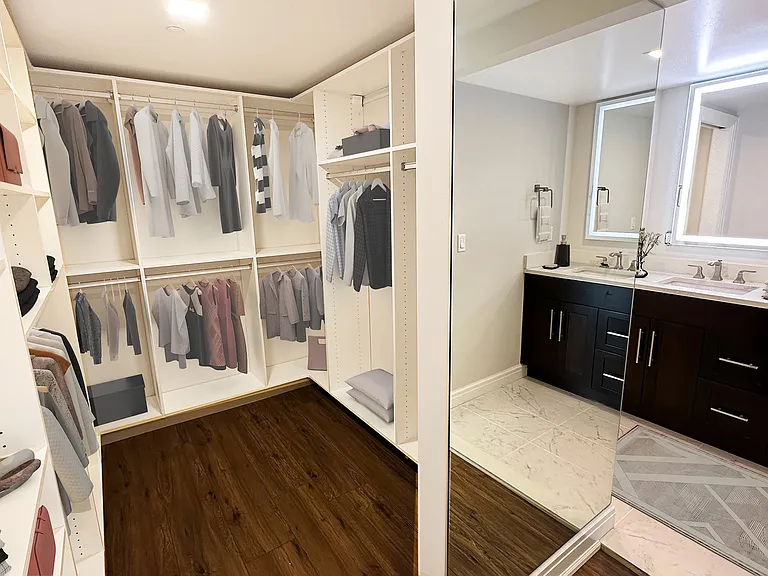 MASTER SUITE CALIFORNIA WALK-IN CLOSET TO DOUBLE WHITE MARBLE VANITY AND BACK-LIT MIRRORS