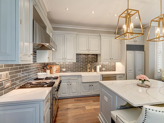 Marble-top island includes microwave drawer and seating for 4.