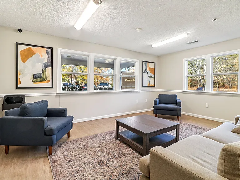 Spend time in our stylish community living area featuring comfortable seating options and coffee table, professionally operated by Highlands Vista Group.