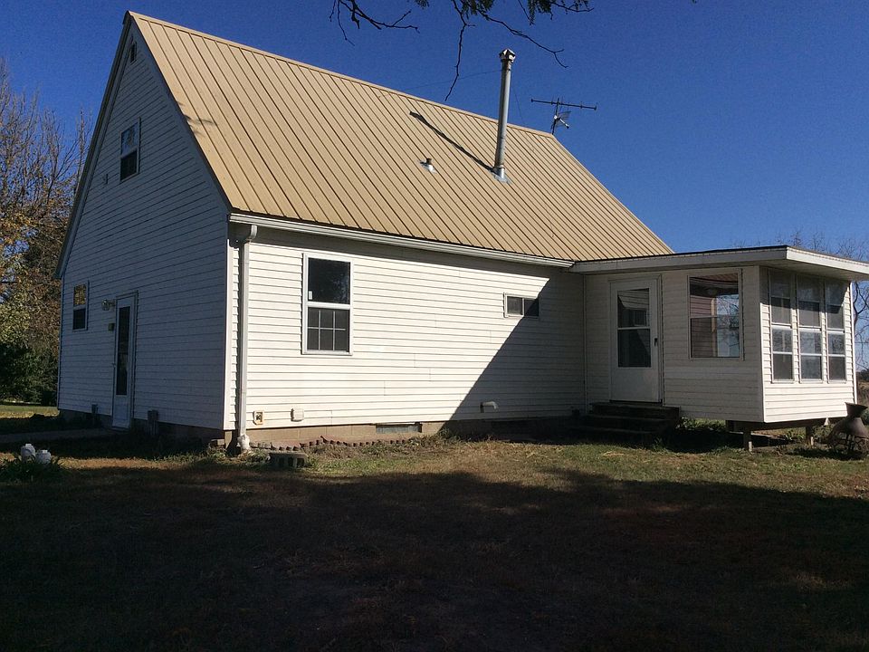 South side of house, attached/unheated porch shown