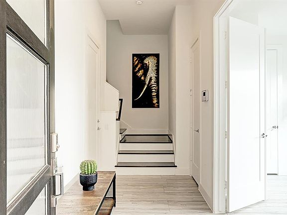 First floor includes access to the garage, bedroom with en-suite bathroom, access to the backyard, and oak treads.