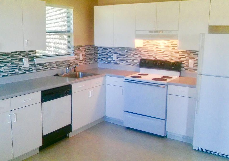 remodeled kitchen counters and fixtures, with backsplash, wi
