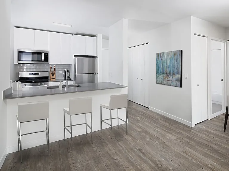 Renovated Package I kitchen and dining areas with hard surface plank flooring