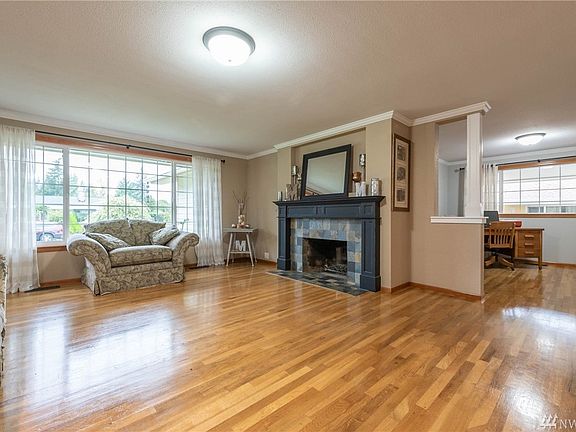 Another view of the living room and home office in the background.