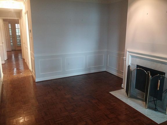 Living room with wood fireplace and crown moulding