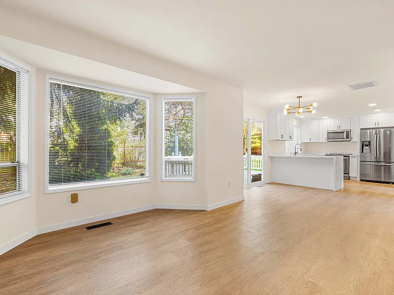 Generous family room filled with natural light, featuring multiple windows