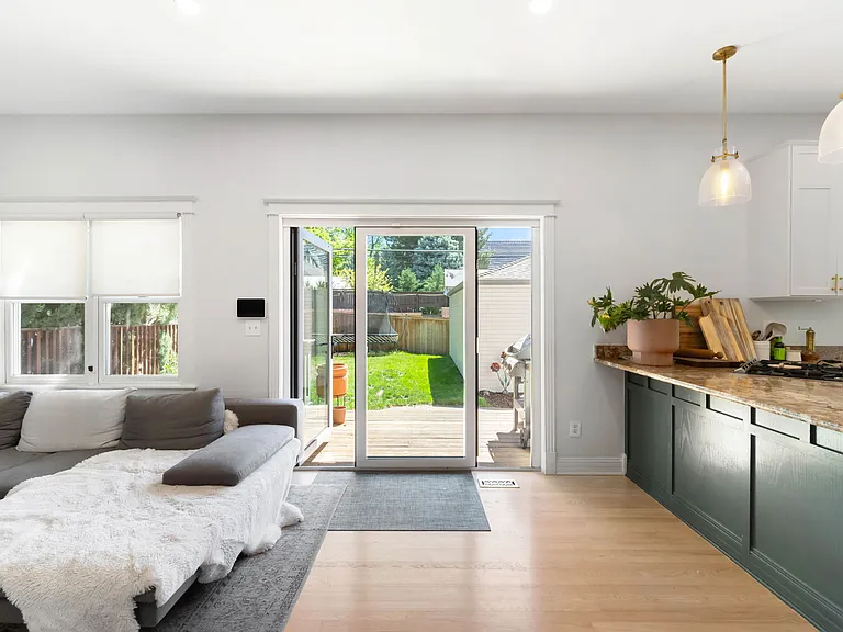 Kitchen and Living Area with Access to the Backyard via a Panoramic Door
