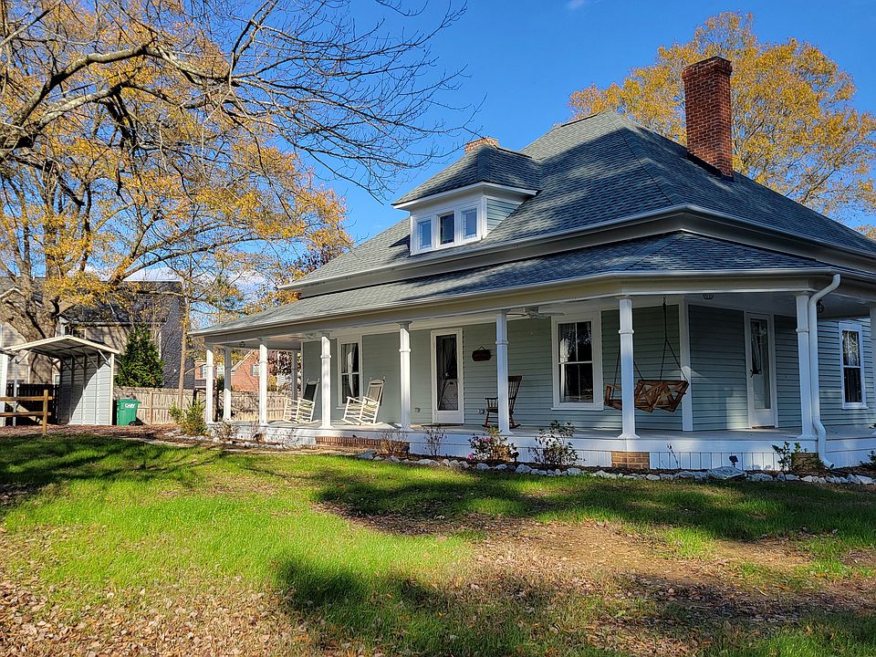 front with garage and carport to right