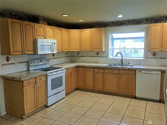 Large kitchen with plenty of counter space and cabinets.