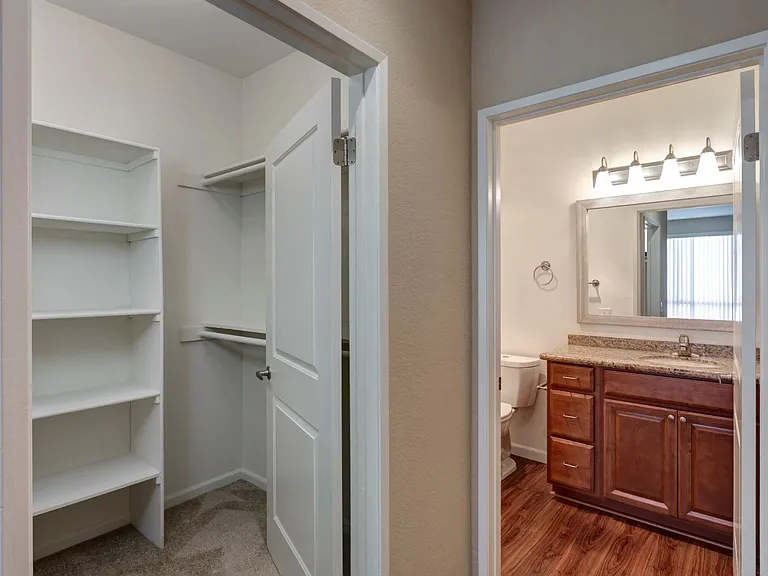 Chelsea Court Two Bedroom Apartment Walk-In Closet with View of Bathroom