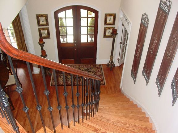 Custom, Curved Staircase w/ Iron Balusters.