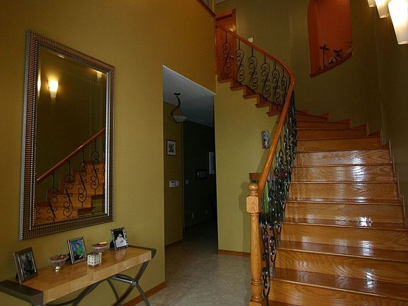 Gorgeous winding staircase at entrace.