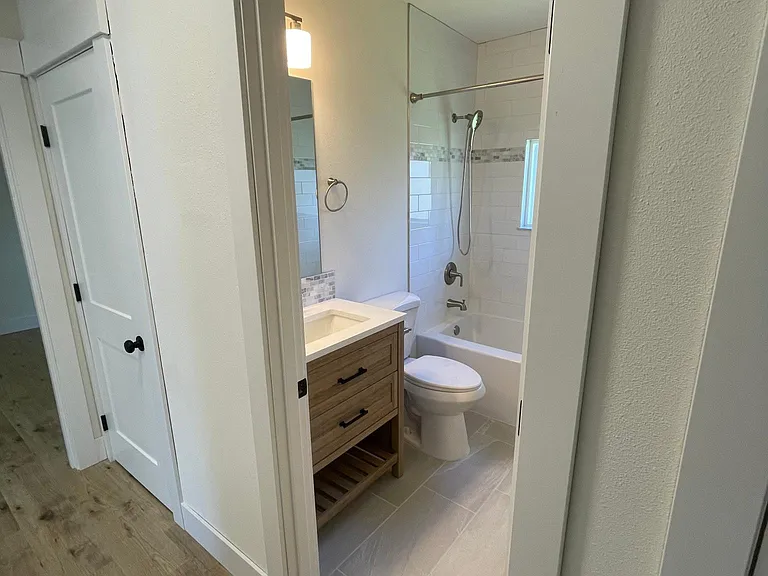 Newly renovated, fully updated throughout. Hall bathroom with subway tile and soaking tub.