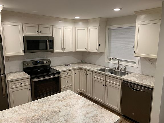 Brand new kitchen with all new appliances & double-bowl stainless steel sink.