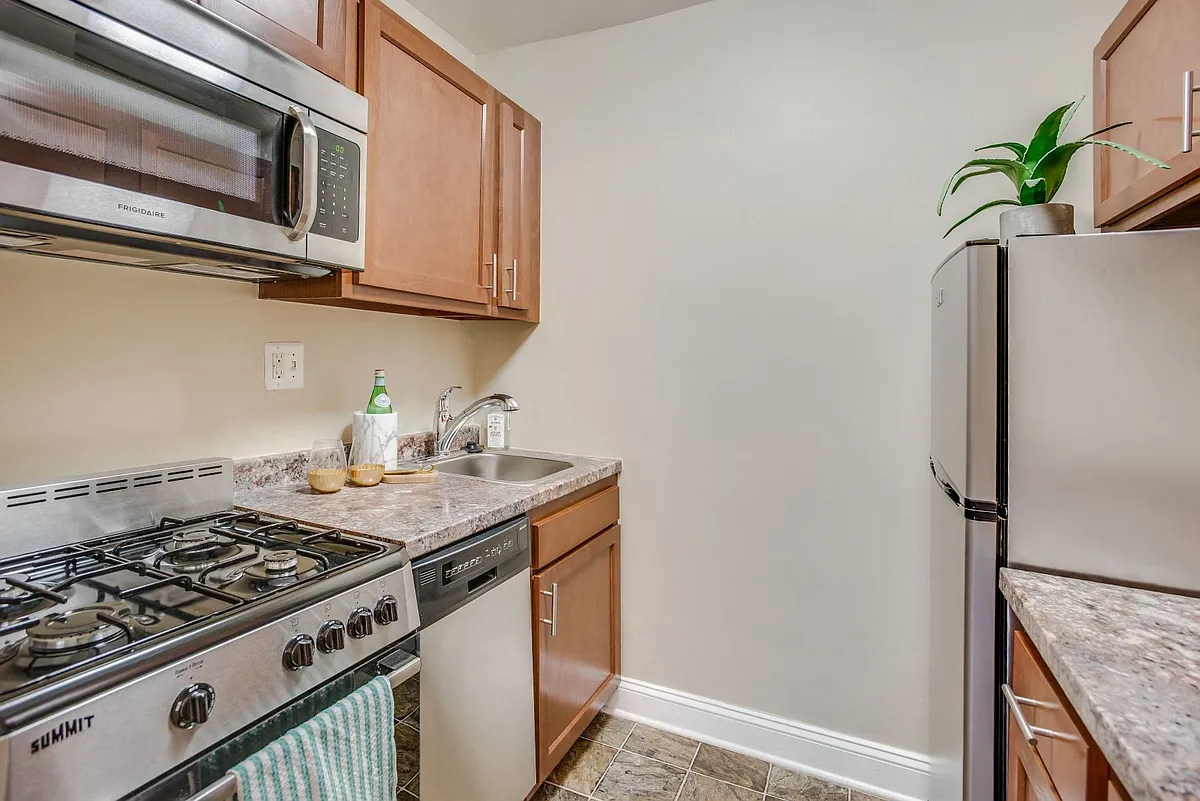 Kitchen with stainless steel appliances - 2231 Ontario Apartments