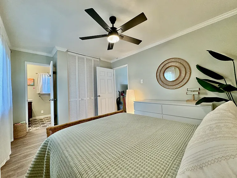 Extra cozy full/double size bed with firm mattress and Tempur-Pedic mattress topper, ceiling fan, chest of drawers, jewelry stand, large closet with plenty of hangers, and attached bathroom