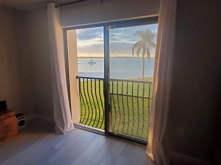 Primary bedroom sliding doors to view of private beach