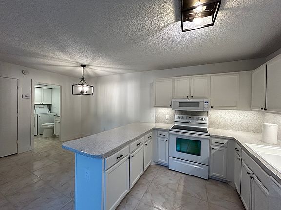 Kitchen showing stove microwave dining room half bathroom