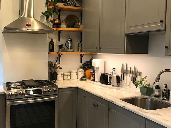 Bright and modern kitchen with marble countertops and soft-close cabinets and drawers.