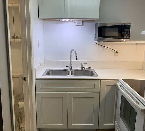 Fully stocked & updated kitchen with new cabinets & quartz counters plus a full size stove.