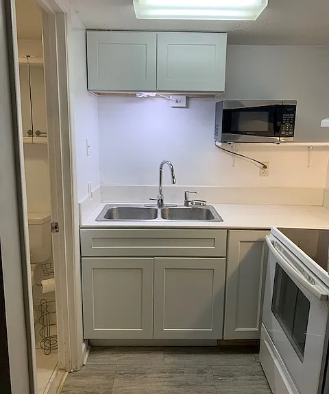 Fully stocked & updated kitchen with new cabinets & quartz counters plus a full size stove.