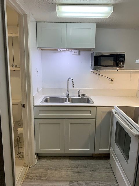 Fully stocked & updated kitchen with new cabinets & quartz counters plus a full size stove.