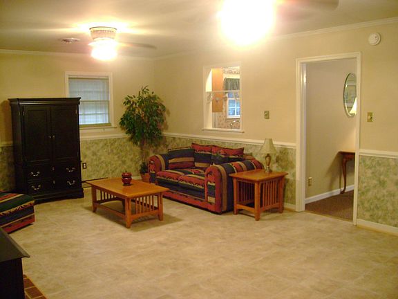 Family Rm laminate floor, ceiling fans, crown molding, chair rail & woodstove