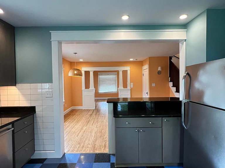 view from kitchen looking into dining and front rooms