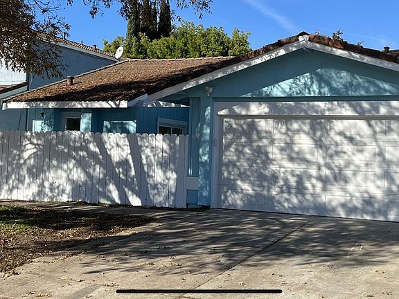 Curbside view of front of home. Secure access to the front entry door is along home_s sidewalk to the left of the house and through the keyed front gate.