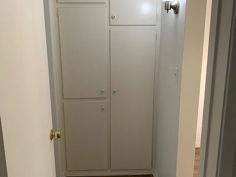 Hallway linen closet with plenty of storage.