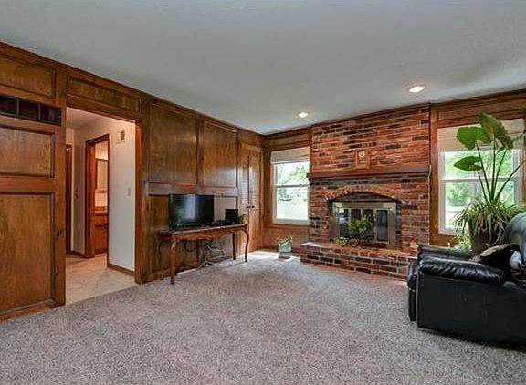 NICE BRICK FIREPLACE AND WET BAR BEHIND SHUTTER DOORS