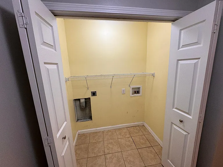 washer and dryer room in master bathroom